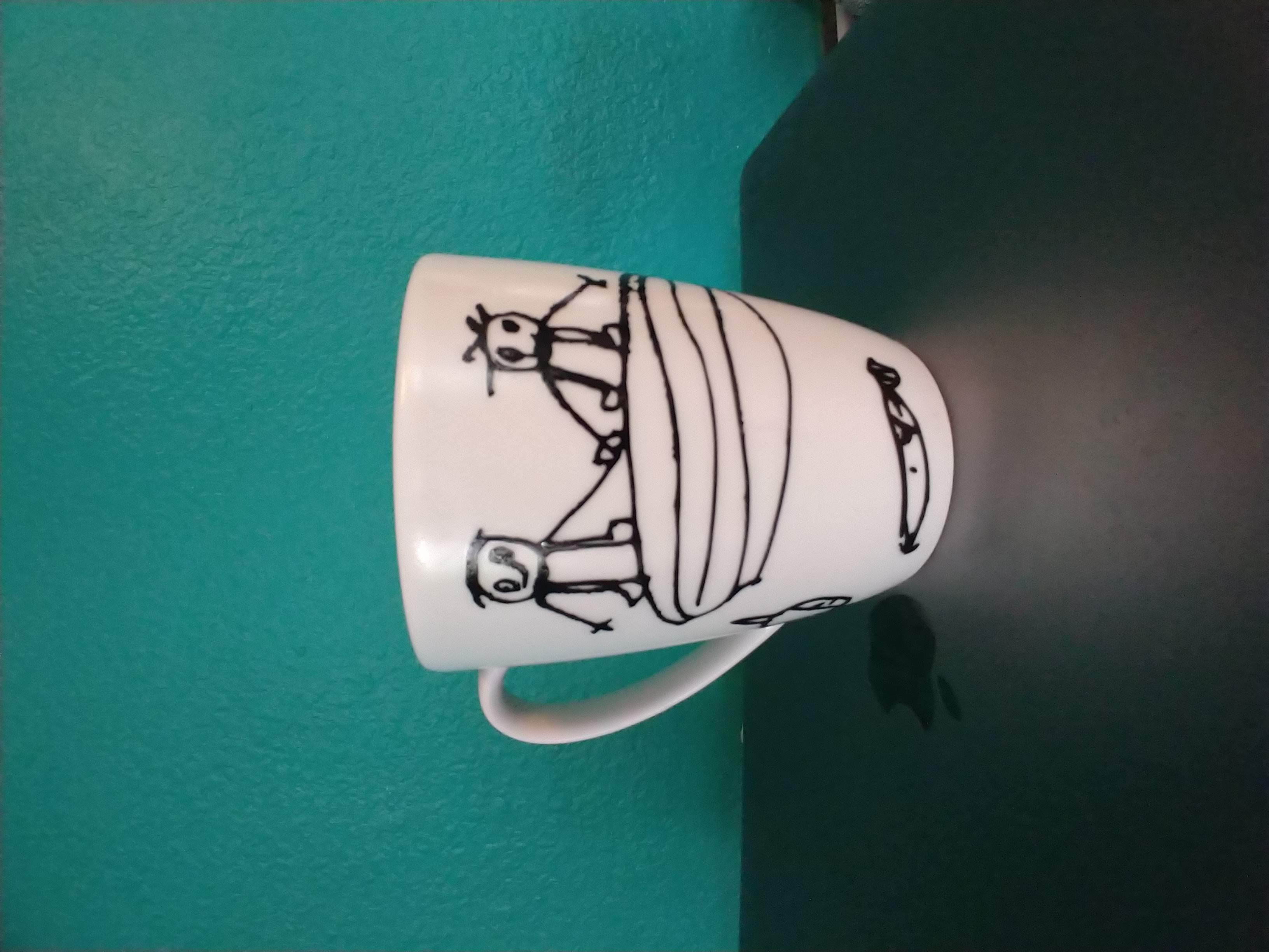 A mug with a child's drawing on it